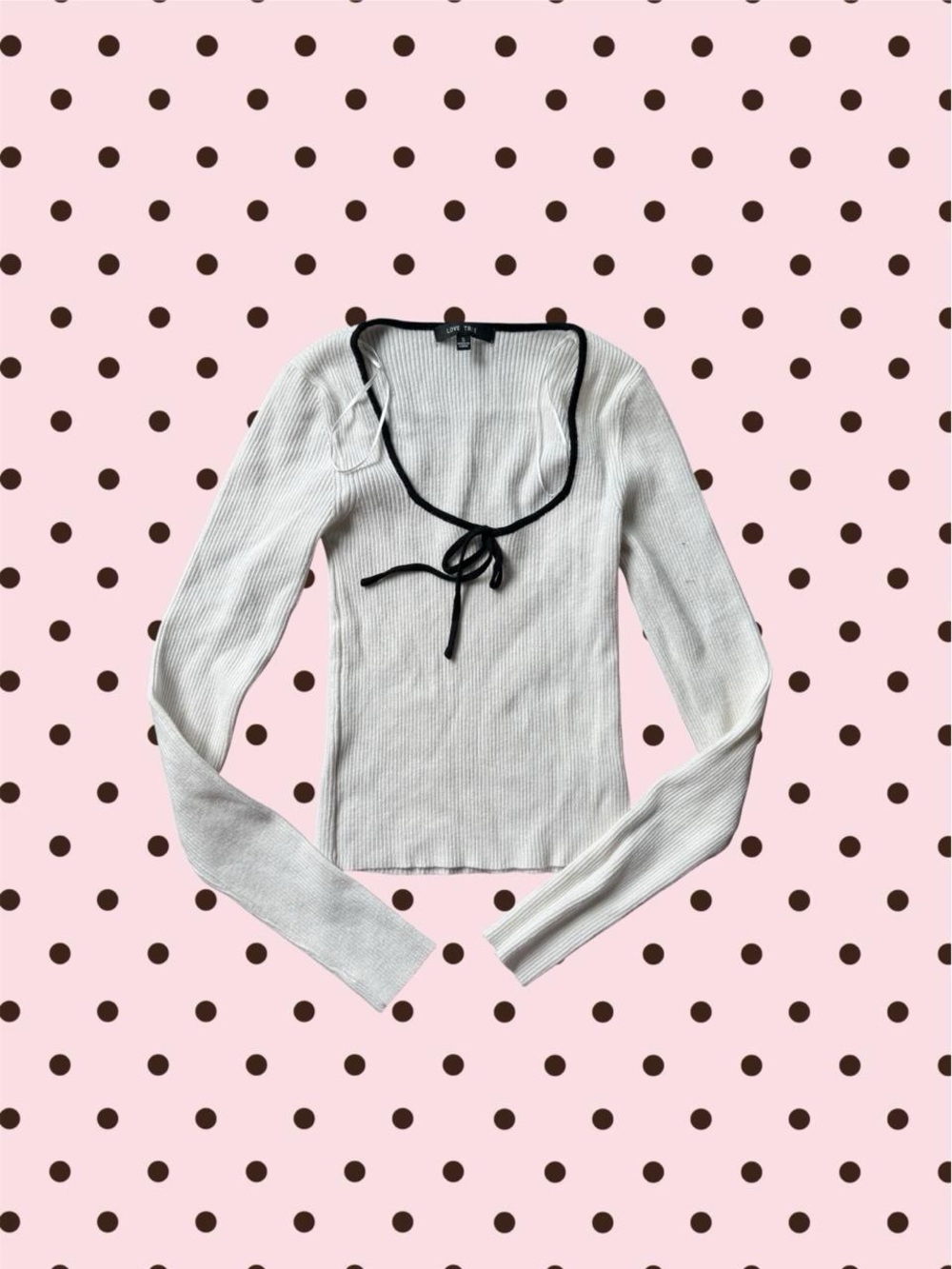 white ribbed knit long sleeve top with black bow detail